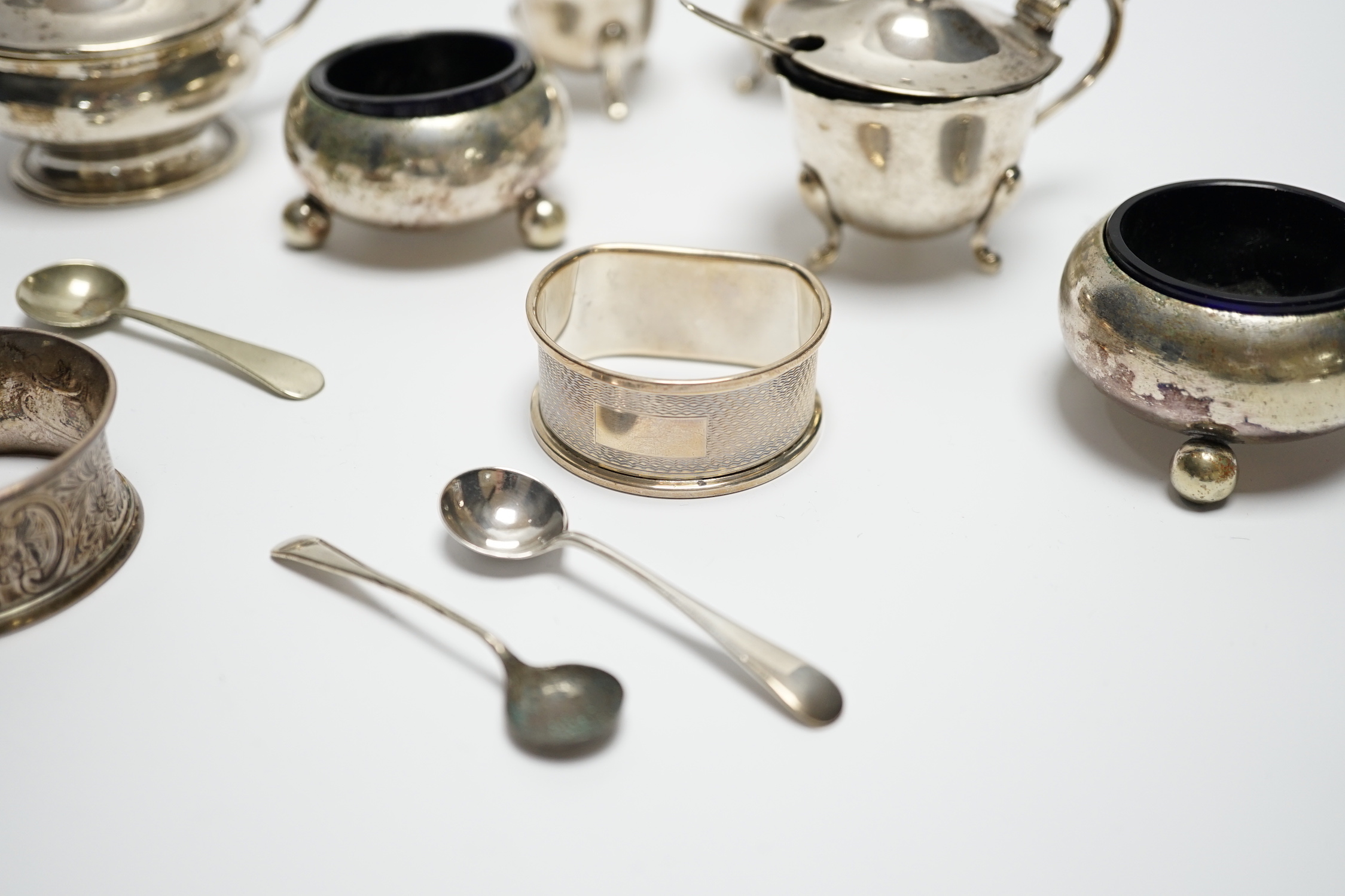 Six assorted silver cruets and three silver napkin rings.
